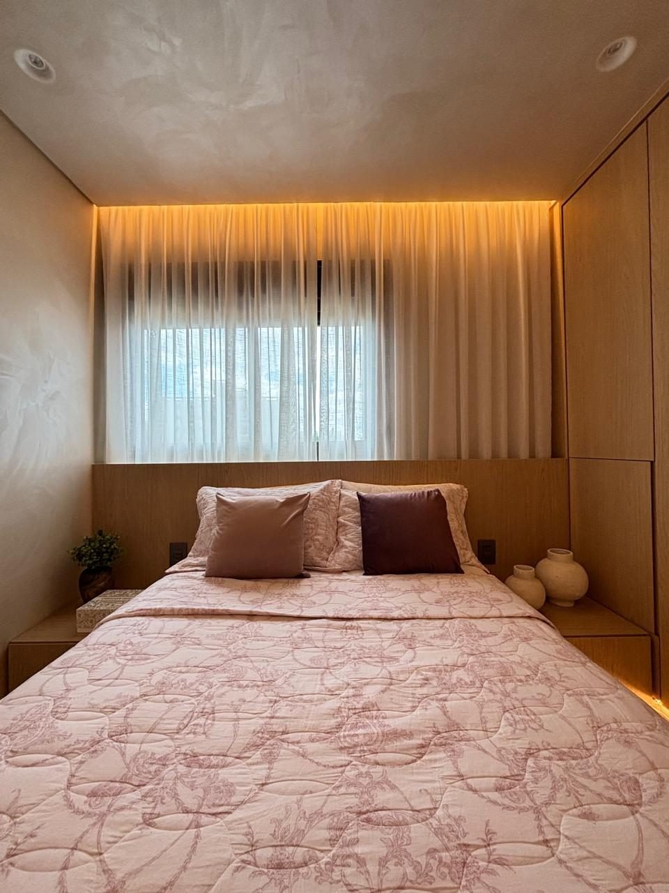 Quarto com painel de madeira e iluminação embutida